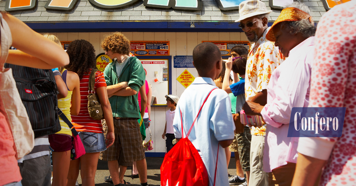Seasonal team member greeting a guest at a kiosk—upsell and thank-you behaviors reinforced through recognition—Confero case study.