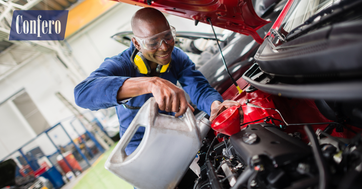 Technician and service advisor at an oil change bay—customer service and safety checks during a Confero mystery shop.